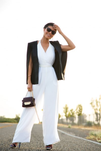 white jumpsuit with v-neck and flap with black blazer
