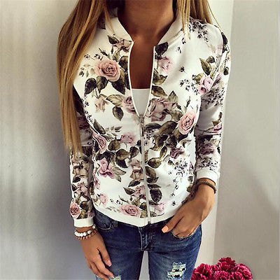white running jacket with floral pattern and blue ribbed skinny jeans