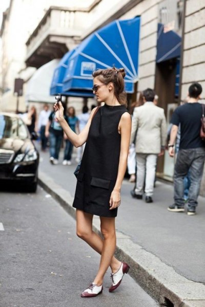 black mock-neck mini dress with white and gray oxford evening shoes