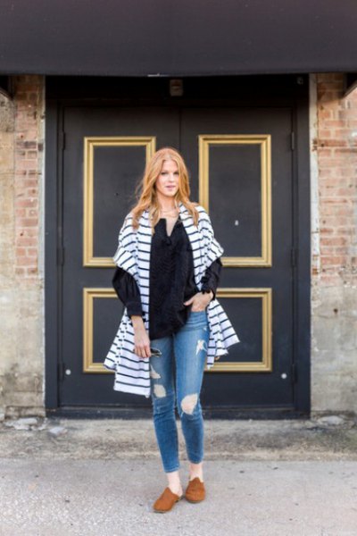 blue and white striped oversized cardigan with torn jeans and brown suede shoes