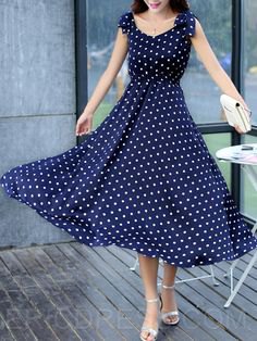 Dark blue maxi dress with a dotted fit and flared maxi dress with silver heels