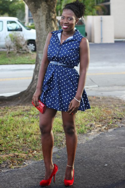 sleeveless mini dress with blue polka dot belt and red heels