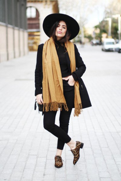 long scarf with orange fringes, black longline blazer and felt hat