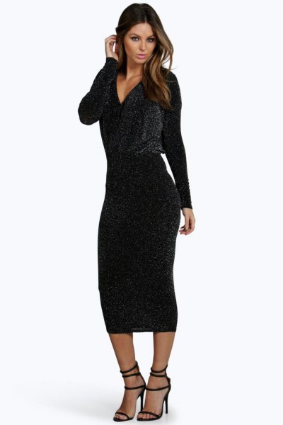 black, low-sleeved, figure-hugging midi dress with deep V-neck and open toe heels