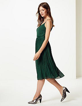 green pleated midi dress with silver heels