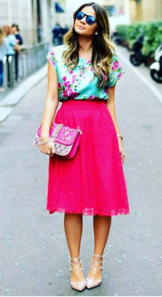 Light blue sleeveless silk blouse with floral print and pink midi skirt
