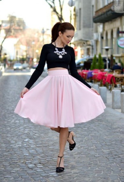 black, short-cut long-sleeved T-shirt with light pink midi skirt
