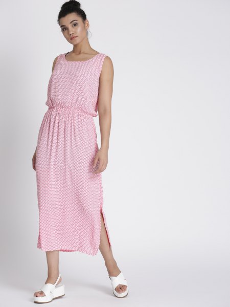 Light pink sleeveless maxi dress with a gathered waist and white sandals