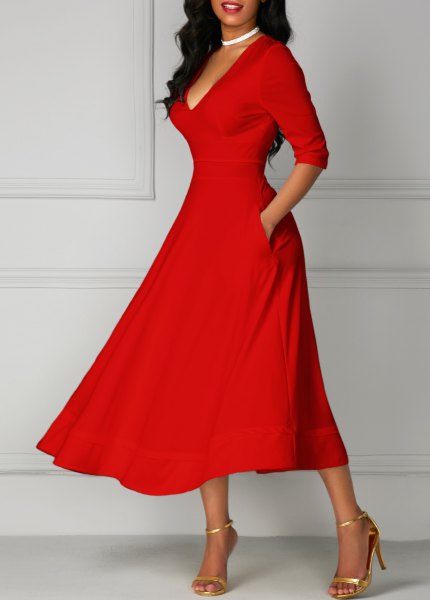 red half-arm with a V-neck and flared midi dress with gold heels