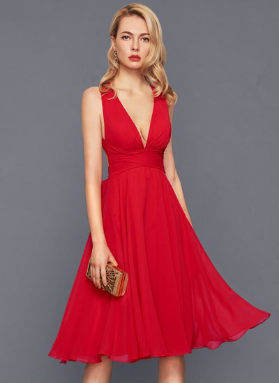 red midi dress with deep v-neck and flared midi dress with clutch wallet