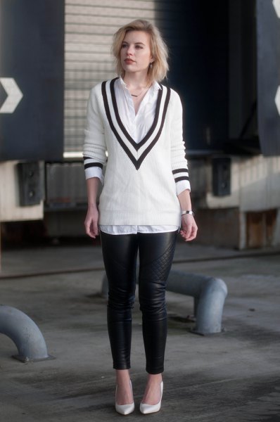 white and black sweater with v-neck, shirt with buttons and leather gaiters