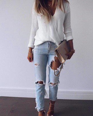 white, oversized sweater with V-neck and blue ribbed slim fit jeans