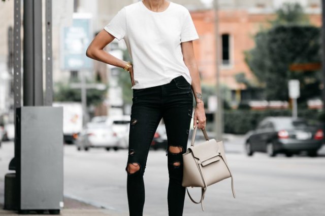 white t-shirt with black skinny jeans and light pink leather handbag