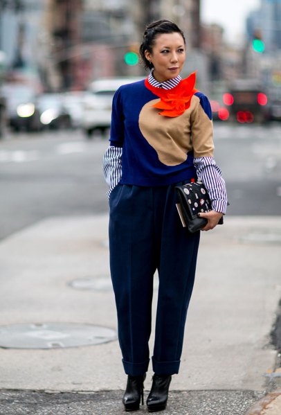 royal blue sweater with a striped shirt with a round collar and black trousers