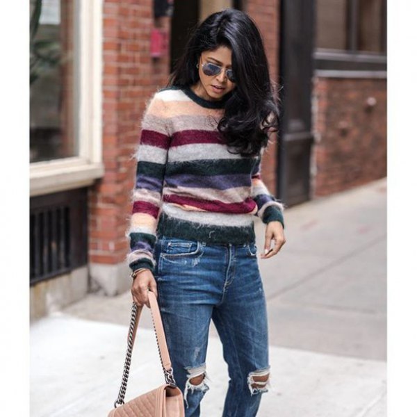 white pink and black striped sweater with destroyed jeans