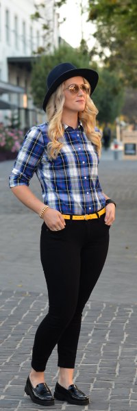 blue and white shirt with yellow belt and black skinny jeans