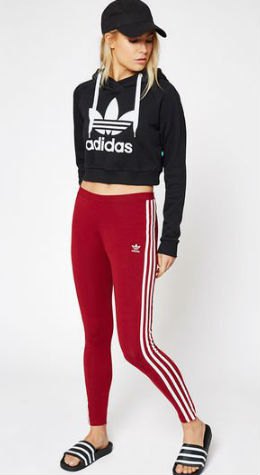 black graphic short cut hoodie with baseball cap and red and white striped leggings