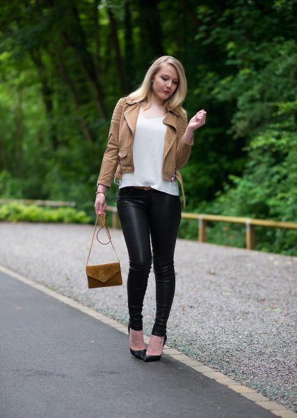 brown leather jacket with white t-shirt with a scoop neck and black leggings
