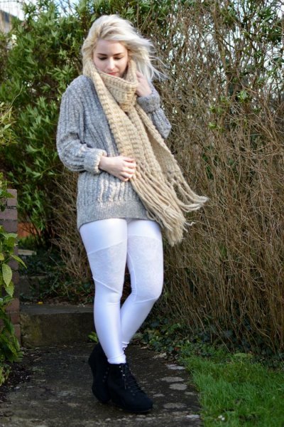 gray, coarse-grained knit sweater with a blushing fringed scarf