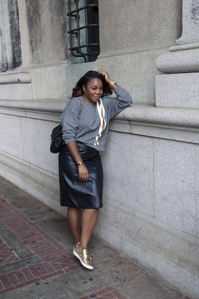 gray, chunky sweater with leather skirt and white-gold sneakers