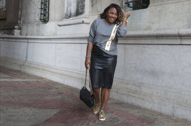 gray sweater with black midi skirt and gold sneakers