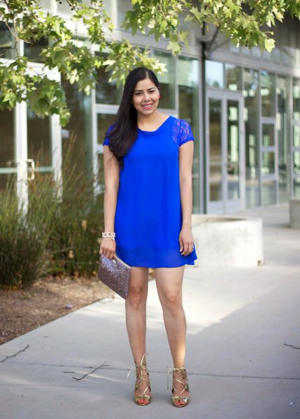 royal blue mini shift dress made of lace with cap sleeves and metallic strappy heels
