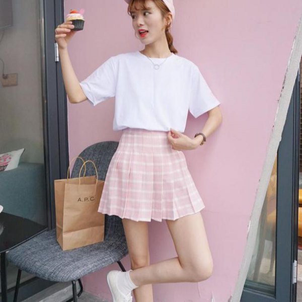 white t-shirt with a relaxed fit and pink and white checkered skater skirt