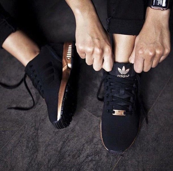 short sweatpants with black and gold running shoes