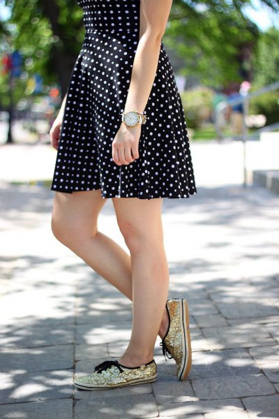 black and white polka dot and flared mini dress with golden sequin sneakers
