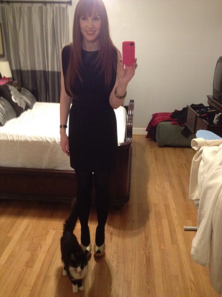 black, form-fitting mini dress with stockings and open toe heels