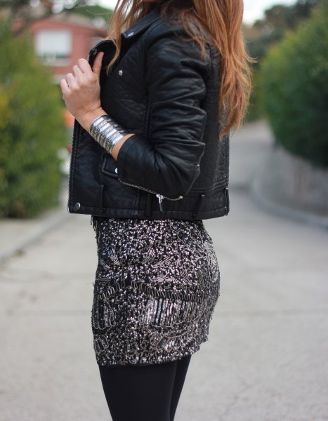 black leather jacket with form-fitting mini skirt