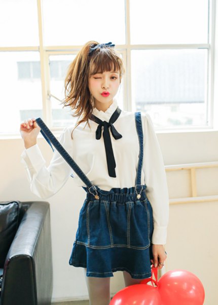 white shirt with buttons, black bow tie and dark blue pleated skirt