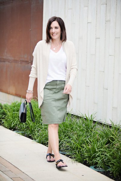 Light pink cardigan with white V-neck t-shirt and knee-length skirt