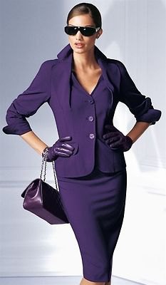 purple skirt suit with black leather handbag
