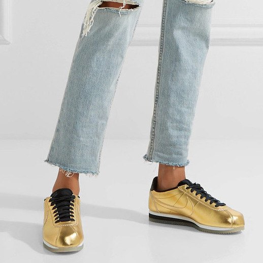 Light blue, torn tubular trousers with golden, comfortable hiking shoes