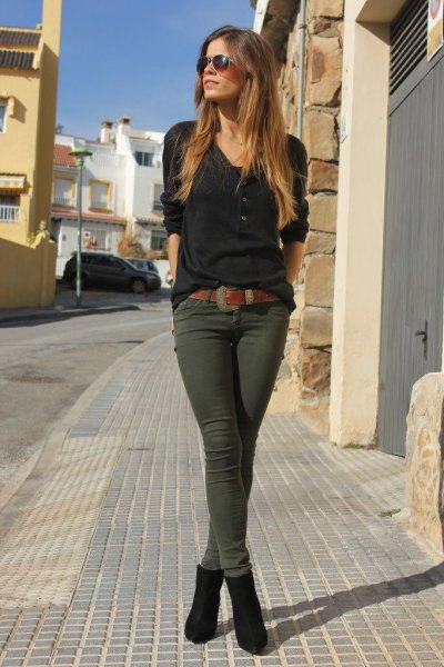 black long-sleeved T-shirt with green skinny trousers and ankle boots