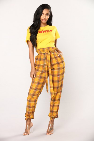 yellow graphic t-shirt with checked trousers with cuffs at the front