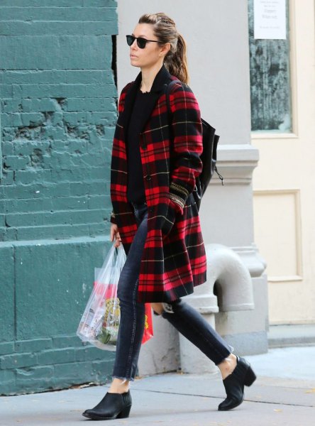 red and black midi checked coat with dark blue skinny jeans