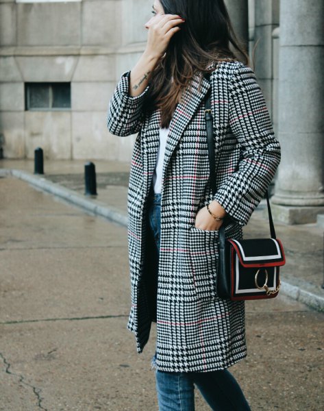 black and white checkered coat with white top and blue jeans