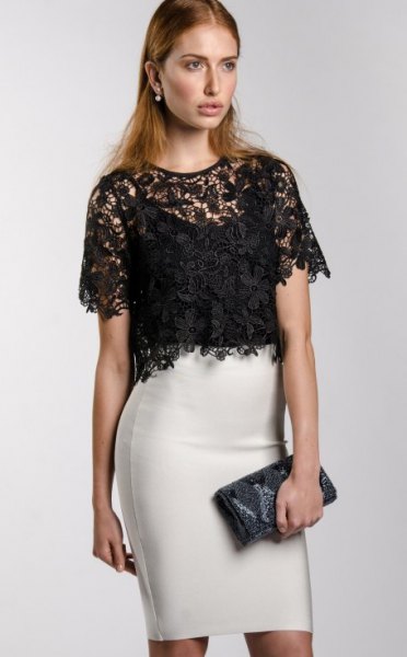 black, short-sleeved, elegant blouse made of lace with white mini skirt