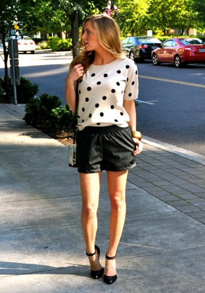 white short-sleeved sweater with polka dots and black leather shorts