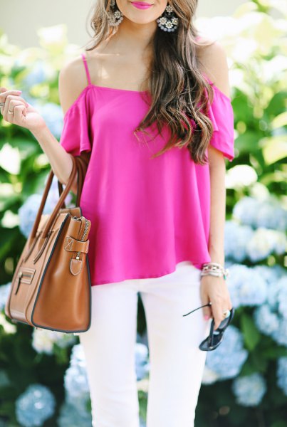 pink cold shoulder blouse with white jeans and brown handbag