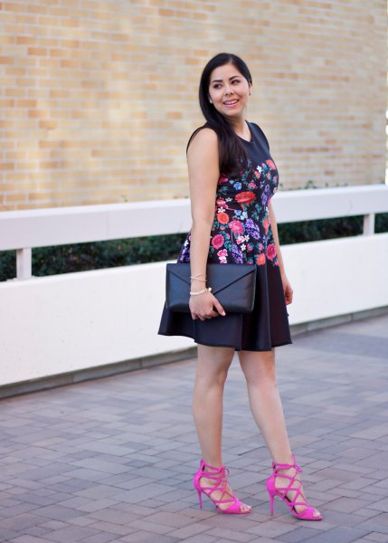 black sleeveless, floral embroidered mini swing dress with pink strappy heels