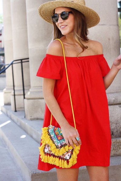 red strapless blouse dress with yellow wallet with tribal print