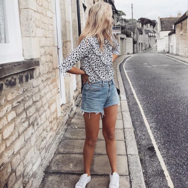Black and white blouse with a leopard print and light blue mini shorts