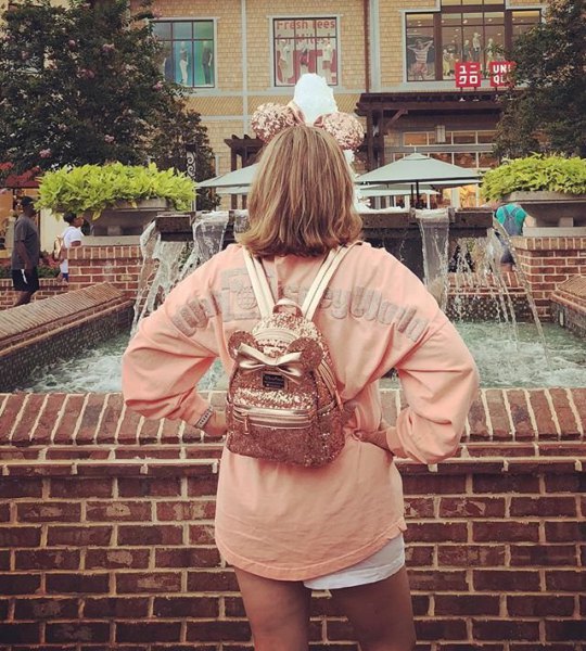 pink oversized long sleeve t-shirt with mini shorts and rose gold backpack wallet