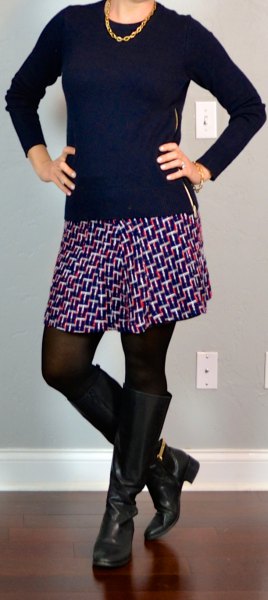 black sweater with scoop neck, printed mini skirt and knee-high zip boots