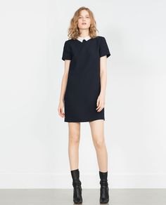 black mini shift dress with leather boots with medium calf leather