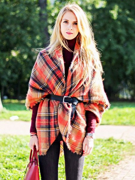 Plaid wrap-around sweater with belt and dark blue jeans