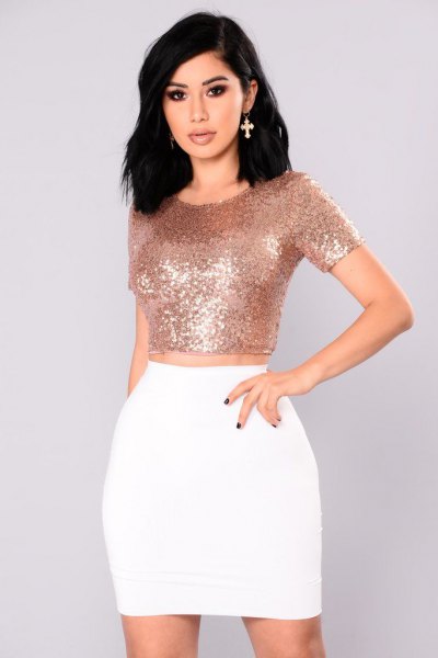 Rose gold figure-hugging crop top with white mini skirt